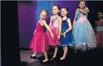  ??  ?? From left, Kaitlin McArthur, six, Amaya Nakai, six, Emma Weaver, six, and Madi Willis, 11, prepare to go on the catwalk.