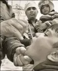  ?? HT PHOTO ?? A health worker delivers polio vaccine drops to a child on National Immunisati­on day, Amritsar, January 28