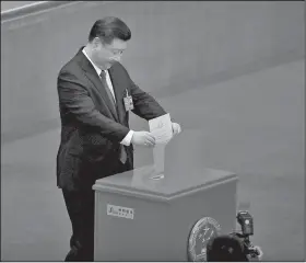  ?? AP/ANDY WONG ?? Chinese President Xi Jinping casts his vote Sunday for an amendment to China’s Constituti­on abolishing term limits on the presidency during a plenary session of the National People’s Congress at the Great Hall of the People in Beijing.