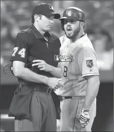  ?? AP/GAIL BURTON ?? Kansas City’s Mike Moustakas (right) argues a called strike with home plate umpire John Tumpane on Wednesday in Baltimore.