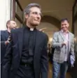  ??  ?? Msgr. Krzysztof Charamsa, left, and his partner, Eduard, right, leave a restaurant after a news conference in downtown Rome on Saturday.