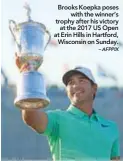  ?? – AFPPIX ?? Brooks Koepka poses with the winner’s trophy after his victory at the 2017 US Open at Erin Hills in Hartford, Wisconsin on Sunday.