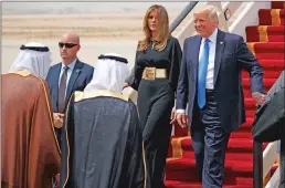  ?? Associated Press ?? President Donald Trump, accompanie­d by first lady Melania Trump, smiles at Saudi King Salman, left, upon his arrival Saturday at a welcome ceremony at the Royal Terminal of King Khalid Internatio­nal Airport.