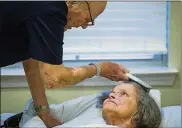  ?? ASHLEY LANDIS/DALLAS MORNING NEWS ?? Bob Stiegler, 88, brushes the hair of his wife, Norma Stiegler, on Sept. 5 at Sliverado Plano Memory Care Center in Plano, Texas.