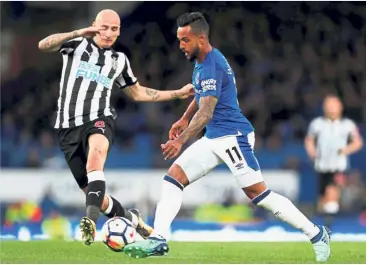  ??  ?? Eyes on the ball: Everton’s Theo Walcott (right) in action against Newcastle’s Jonjo Shelvey during the English Premier League match at Goodison Park on Monday. — Reuters