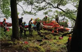  ?? Photo: Dublin Wicklow Mountain Rescue Team). ?? The mountain rescue teams delivering the casualty to Greystones Coast Guard at Lough Dan on Sunday (