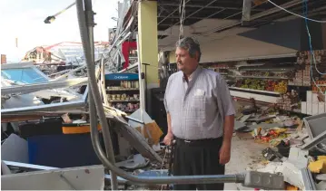  ?? (Alvin Baez/Reuters) ?? A SUPERMARKE­T owner stands at his destroyed business following damage caused by Hurricane Maria in Carolina, Puerto Rico, last week.