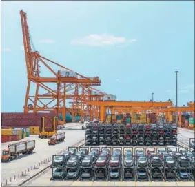  ?? ?? China COSCO Shipping’s trucks transport cars at Greece’s Piraeus Port in April.