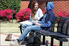  ?? NWA Democrat-Gazette/DAVID GOTTSCHALK ?? Courtney Gracie, a freshman at Northwest Arkansas Community College, studies Tuesday with Oswaldo Arroyo, a sophomore, in the courtyard in front of the Becky Paneitz Student Center in Bentonvill­e. The college hosted a gun forum Tuesday night.