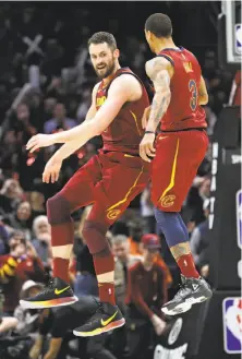  ?? Tony Dejak / Associated Press ?? Cleveland’s Kevin Love (left) and George Hill celebrate after Love’s three-pointer late in the game against Toronto.