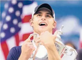  ?? AMY SANCETTA/AP ?? Andy Roddick celebrates with the U.S. Open trophy in 2003. It was the last time an American man won a Grand Slam tournament. Roddick retired in 2012 at age 30.