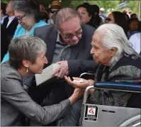  ?? The Associated Press ?? 2016: In this July 19, 2016, file photo, Hank Adams, center, looks on as U.S. Interior Secretary Sally Jewell, left, greets 92 year-old Maiselle Bridges, right, during the celebratio­n of the renaming of Nisqually National Wildlife Refuge near Olympia, Wash.