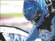  ?? HAKIM WRIGHT SR./AP ?? KEVIN HARVICK climbs into his car before qualifying for the NASCAR Cup Series auto race at Atlanta Motor Speedway on Saturday in Hampton, Ga.