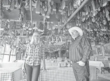  ?? MICHAEL SCHENNUM / THE REPUBLIC ?? Lisa Cyr, a Pinnacle Peak Patio spokeswoma­n, and Scott Browning, the restaurant’s manager, stand beneath some of the neckties hung from the restaurant’s ceiling over the past six decades. The restaurant opened in June 1957 and will close June 28.