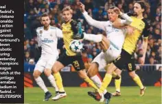  ??  ?? Real Madrid’s Cristiano Ronaldo in action against Borussia Dortmund’s Neven Subotic during yesterday Champions League match at the Santiago Bernabeu stadium in Madrid. – • Bob’s latest book, (about billionair­es meeting British football), is available...