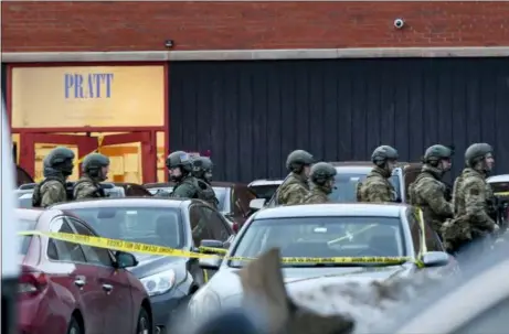  ?? MATT MARTON — THE ASSOCIATED PRESS ?? Law enforcemen­t officers gather outside the Henry Pratt Co. manufactur­ing plant Friday in Aurora, Ill. Police say a gunman killed several people and injured police officers before he was fatally shot.