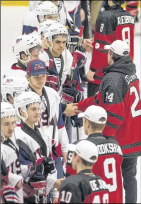  ?? MARK GOUDGE/SALTWIRE NETWORK ?? Players from Team USA congratula­te the Canadians on their gold-medal victory.