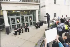  ??  ?? Greenwich police officers take a knee with protesters.