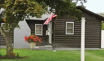  ??  ?? Great-uncle: Adolf Hitler in 1924, a Stars and Stripes flag flying outside Alexander Stuart-Houston’s home in Long Island and young Alexander, above