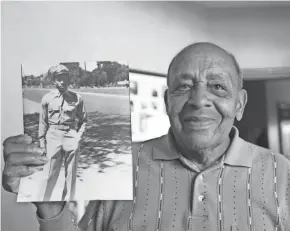  ?? FILE ?? Harold Brown, a Tuskegee Airman, holds a picture of himself at 20 years old after he returned home from World War II.