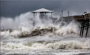  ?? TRAVIS LONG/THE NEWS & OBSERVER VIA AP ?? Waves slam the Oceana Pier &amp; Pier House Restaurant in Atlantic Beach, N.C., Thursday as Hurricane Florence approaches the area.