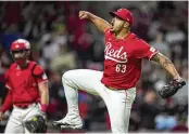  ?? AARON DOSTER / ASSOCIATED PRESS ?? Cincinnati Reds’ Fernando Cruz celebrates as he walks to the dugout after the final out in the top of the seventh inning of the team’s game against the Philadelph­ia Phillies in Cincinnati on Wednesday.