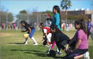  ??  ?? A group of young softball players get in position to catch an incoming ground ball during Imperial Valley College’s second annual allskills softball camp.