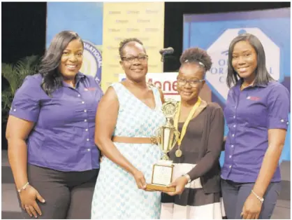  ??  ?? Alexandra Vaz (second right), winner of the Optimist Internatio­nal Oratorical Competitio­n Caribbean District finals holds the trophy with her mother, Charmaine Samuels-cole, at held at the TVJ studios in April. Also sharing in the occasion are Sanya Wallace (left) senior manager, strategic planning, reporting and marketing at JN Money Services (JNMS), and Tanisha Cowan, marketing officer at JNMS.