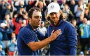  ?? ROSS KINNAIRD / GETTY IMAGES ?? European players Francesco Molinari (left) and Tommy Fleetwood celebrate on No. 14 during the afternoon foursome matches.