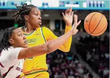  ?? Sean Rayford/Associated Press ?? South Carolina forward Ashlyn Watkins, left, reaches for the ball against Norfolk State guard Tamiya Santos.