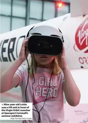  ?? Hugh Hastings/Getty Images ?? Nine-year-old Lottie uses a VR unit in front of the Virgin Orbit Launcher at Spaceport Cornwall’s summer exhibiton