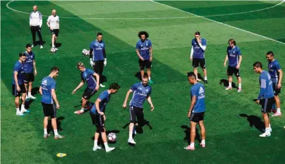  ?? —AFP ?? MADRID: Real Madrid players attend a training session at Valdebebas Sport City yesterday on the eve of their last Liga football match, against Malaga.