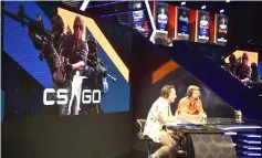  ??  ?? eSports gaming commentato­rs talk to the crowd during a competitio­n.