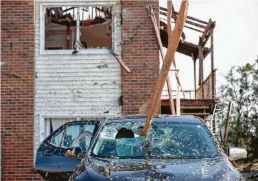  ?? Whitney Curtis / New York Times ?? A series of powerful tornadoes whipped across the Midwest this week, killing at least three people in southweste­rn Missouri and destroying buildings and homes in that state’s capital, Jefferson City.