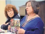  ??  ?? Karen Hutchison shows a photo collage of her son Tyler Burgess during the support group of the Resource Center for Victims of Violent Death in late March.