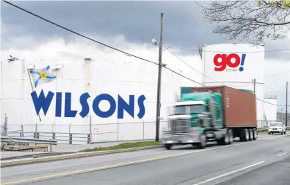  ?? RYAN TAPLIN • THE CHRONICLE HERALD ?? Vehicles pass by Wilson Fuel storage tanks on Barrington Street in Halifax on Wednesday, A fuel pipeline shutdown in the U.S. has local drivers nervous about the possibilit­y of gasoline shortages.