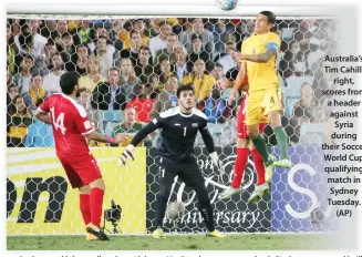  ??  ?? Australia’s Tim Cahill, right, scores from a header against Syria during their Soccer World Cup qualifying match in Sydney Tuesday. (AP)