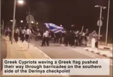  ??  ?? Greek Cypriots waving a Greek flag pushed their way through barricades on the southern side of the Derinya checkpoint