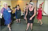  ?? CHRISTINE PETERSON/WORCESTER TELEGRAM & GAZETTE VIA AP ?? Members of the Nereids Swim Club at the YWCA in Worcester, Mass., dance in the 1920s style Wednesday, Oct. 2. The club is celebratin­g 90 years at the YWCA.