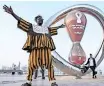  ?? ?? A FAN of Ghana’s national football team poses with the Fifa World Cup countdown clock in Doha. | AFP