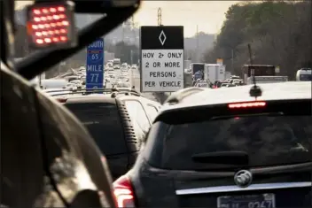  ?? ANDREW NELLES — THE TENNESSEAN VIA AP ?? Signs mark an HOV lane on Interstate 65in Nashville, Tenn., on Dec. 6, 2022. Southern states are more frequently turning to pay-to-use express lanes as a way to address highway congestion without raising taxes. Republican Gov. Bill Lee wants to consider them in Tennessee, one of 16states without any toll roads.