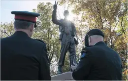  ??  ?? Canadian military personnel applaud the unveiling of the Trans Canada Respect Monument on the south side of Highway 40 in Kirkland.