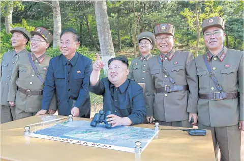  ?? REUTERS/KCNA ?? North Korean leader Kim Jong-un inspects the Pukguksong-2’s missile launch test with Kim Jong-sik, second left, Ri Pyong-chol, third left, and Jang Chang-ha, right.