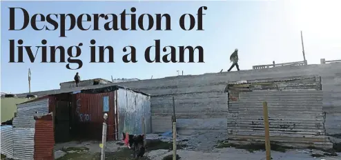  ?? Pictures: Ruvan Boshoff ?? The unstable dam wall of ‘Covid’, a new informal settlement in the Driftsands Nature Reserve. The area is in danger of being flooded in the winter.