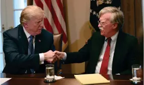  ?? AP PHOTO BY SUSAN WALSH ?? In this April 9, 2018 file photo, President Donald Trump, left, shakes hands with national security adviser John Bolton in the Cabinet Room of the White House in Washington at the start of a meeting with military leaders. Trump has fired national security adviser John Bolton. Trump tweeted Tuesday that he told Bolton Monday night that his services were no longer needed at the White House.