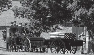  ?? Jose Luis Magana / Associated Press ?? A horse-drawn caisson carries Sen. John McCain’s casket to his burial site in the Naval Academy cemetery.