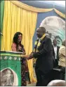  ??  ?? President Cyril Ramaphosa, being garlanded by Amsha Naidoo, the sister of Lenny Naidu (fighter of the undergroun­d Struggle), at the Chatsworth Youth Centre.