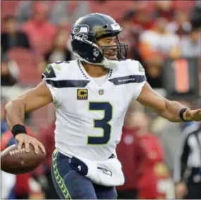  ?? DON FERIA — THE ASSOCIATED PRESS ?? Seahawks quarterbac­k Russell Wilson presents a different kind of challenge for the Eagles Sunday night in Seattle.