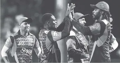  ?? CPL T20 VIA GETTY IMAGES ?? From left: Samuel Badree, Jonathan Carter, Mohammed Nabi and Chris Gayle of St Kitts and Nevis Patriots celebrate the dismissal of Trevon Griffith of the Jamaica Tallawahs during Match 20 of the 2017 Hero Caribbean Premier League at Warner Park on...