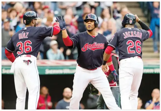  ??  ?? Yandy Diaz (36) and Austin Jackson (26) celebrate with Edwin Encarnacio­n of the Cleveland Indians after all scored on a home run by Encarnacio­n during the first inning against the Baltimore Orioles at Progressiv­e Field on Friday in Cleveland, Ohio. (AFP)